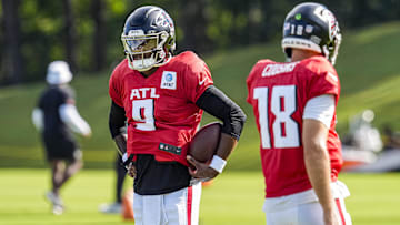Jul 29, 2025; Atlanta, GA, USA; Atlanta Falcons quarterback Michael Penix Jr. (9) shown next to quarterback Kirk Cousins (18) during practice at training camp at IBM Performance Field.
