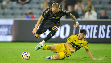 Jul 13, 2024; Los Angeles, California, USA; LAFC midfielder Mateusz Bogusz (19) and Columbus Crew midfielder Sean Zawadzki (25) battle for the ball in the second half at BMO Stadium. Mandatory Credit: Kirby Lee-USA TODAY Sports