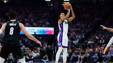 Mar 17, 2025; Sacramento, California, USA; Sacramento Kings forward Keegan Murray (13) shoots against Portland Trail Blazers forward Deni Avdija (8) during the first quarter at Golden 1 Center. Mandatory Credit: Sergio Estrada-Imagn Images