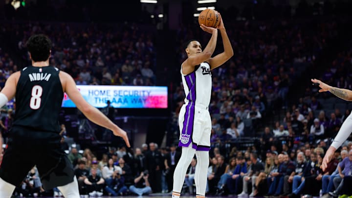 Mar 17, 2025; Sacramento, California, USA; Sacramento Kings forward Keegan Murray (13) shoots against Portland Trail Blazers forward Deni Avdija (8) during the first quarter at Golden 1 Center. Mandatory Credit: Sergio Estrada-Imagn Images