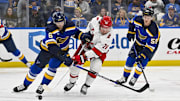 Apr 12, 2024; St. Louis, Missouri, USA;  St. Louis Blues defenseman Marco Scandella (6) and Carolina Hurricanes left wing Brendan Lemieux (28) battle for the puck during the first period at Enterprise Center. Mandatory Credit: Jeff Curry-Imagn Images