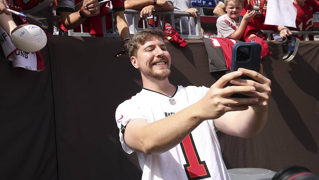 Oct 22, 2023; Tampa, Florida, USA;  YouTuber Jimmy Donaldson MrBeast takes photos with fans before a game between the Atlanta Falcons and Tampa Bay Buccaneers at Raymond James Stadium. Mandatory Credit: Nathan Ray Seebeck-Imagn Images