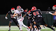 Toombs Quarterback TJ Stanley attempts to break away from Savannah Christian's Elijah Griffin along with LaDamion Guyton