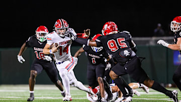 Toombs Quarterback TJ Stanley (14) attempts to break away from Savannah Christian's Elijah Griffin (No. 95) while his Raider teammate LaDamion Guyton (N0. 18) pursues Stanley from behind in a game at Pooler Stadium on Nov. 1, 2024.