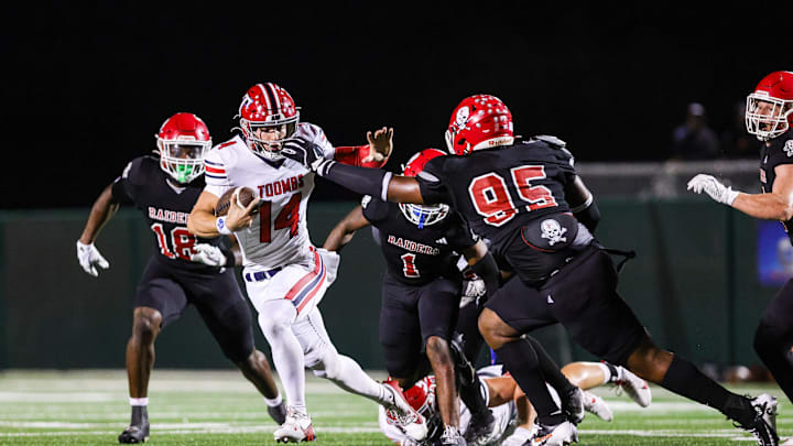 Toombs Quarterback TJ Stanley attempts to break away from Savannah Christian's Elijah Griffin along with LaDamion Guyton