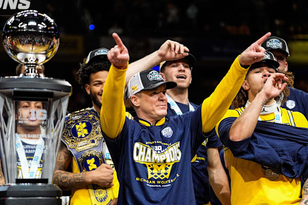 Michigan head coach Dusty May acknowledges the fans as the team celebrate 59-53 win over Wisconsin to win the Big Ten Tournam