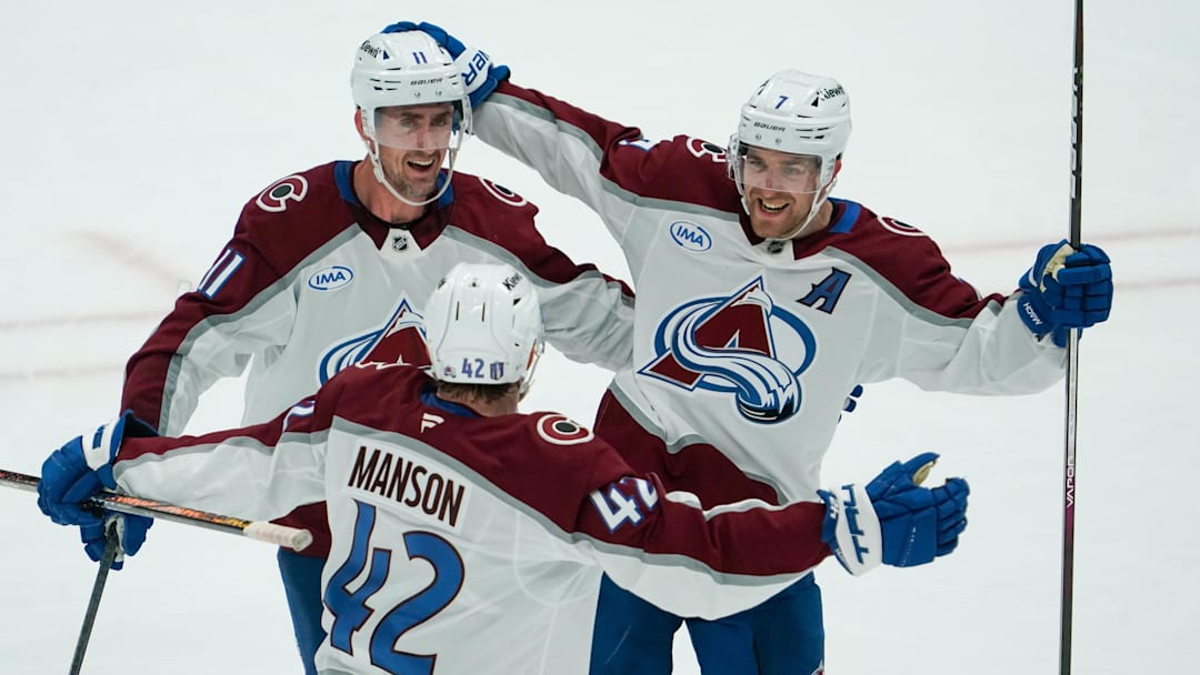 Apr 19, 2025; Dallas, Texas, USA; Colorado Avalanche defenseman Devon Toews (7) celebrates with center Brock Nelson (11) and defenseman Josh Manson (42) after scoring a goal against the Dallas Stars during the third period in game one of the first round of the 2025 Stanley Cup Playoffs at American Airlines Center. Mandatory Credit: Raymond Carlin III-Imagn Images