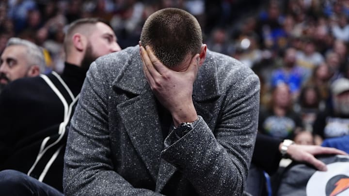 Jan 18, 2026; Denver, Colorado, USA; Denver Nuggets center Nikola Jokic (15) reacts from the bench in the third quarter against the Charlotte Hornets at Ball Arena. Mandatory Credit: Ron Chenoy-Imagn Images