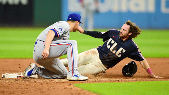 Aug 23, 2024; Cleveland, Ohio, USA; Cleveland Guardians third baseman Daniel Schneemann (10) steals second as Texas Rangers shortstop Corey Seager (5) makes the tag during the fifth inning at Progressive Field. Mandatory Credit: Ken Blaze-USA TODAY Sports