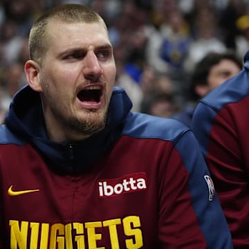Mar 15, 2025; Denver, Colorado, USA; Denver Nuggets center Nikola Jokic (15) reacts from the bench in the second quarter against the Washington Wizards at Ball Arena. Mandatory Credit: Ron Chenoy-Imagn Images