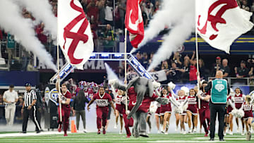 Big Al and the Alabama cheerleaders lead the Crimson Tide onto the field before the 2021 College Football Playoff Semifinal game at the 86th Cotton Bowl in AT&T Stadium in Arlington, Texas Friday, Dec. 31, 2021. Alabama defeated Cincinnati 27-6 to advance to the national championship game. [Staff Photo/Gary Cosby Jr.]
