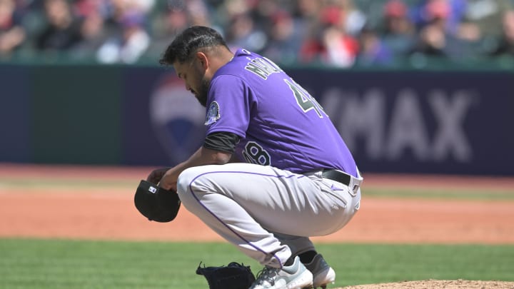 Apr 26, 2023; Cleveland, Ohio, USA; Colorado Rockies starting pitcher German Marquez (48) crouches on the mound before leaving the game during the fourth inning against the Cleveland Guardians at Progressive Field.