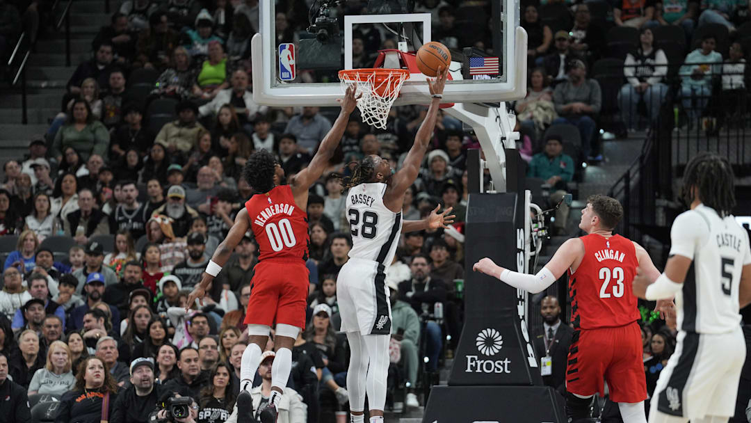 Dec 21, 2024; San Antonio, Texas, USA;  San Antonio Spurs center Charles Bassey (28) shoots the ball against Portland Trail Blazers guard Scoot Henderson (00) in the first half at Frost Bank Center. `