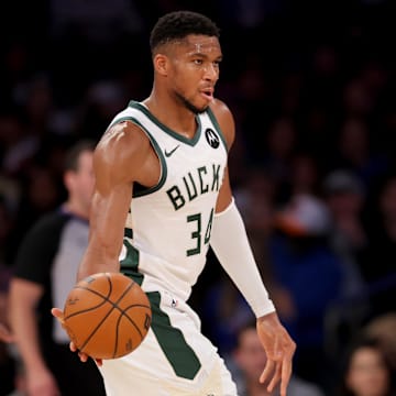 Milwaukee Bucks forward Giannis Antetokounmpo looks to pass the ball against New York Knicks guard Josh Hart. Mandatory Credit: Brad Penner-Imagn Images