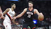 Nov 14, 2025; Houston, Texas, USA;  Houston Rockets center Alperen Sengun (28) dribbles the ball as Portland Trail Blazers forward Kris Murray (24) defends during the second quarter at Toyota Center. Mandatory Credit: Troy Taormina-Imagn Images