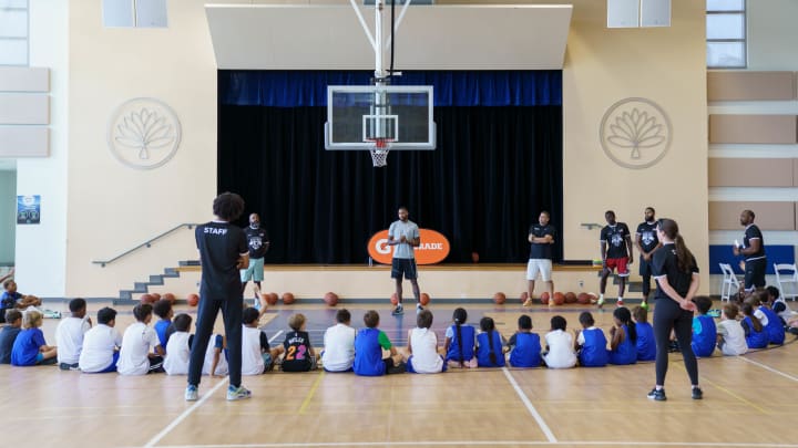 San Antonio Spurs guard Blake Wesley (14) stands in front of a crowd of kids while coaching at the Camana Bay and Jr. NBA/Jr. WNBA Basketball Camp in the Cayman Islands. 