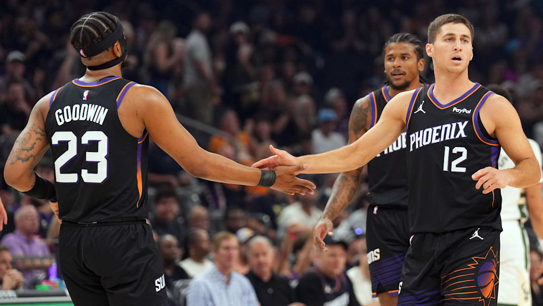 Mar 21, 2026; Phoenix, Arizona, USA; Phoenix Suns guard Jordan Goodwin (23) and Phoenix Suns guard Collin Gillespie (12) slap hands against the Milwaukee Bucks during the first half at Mortgage Matchup Center. Mandatory Credit: Joe Camporeale-Imagn Images