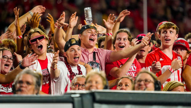 Nebraska Cornhuskers fans sing during a break in the third set against the Omaha Mavericks 