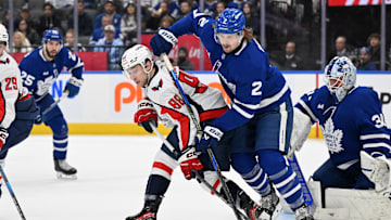 Dec 28, 2024; Toronto, Ontario, CAN;  Toronto Maple Leafs defenseman Simon Benoit (2) battles for the puck with Washington Capitals forward Andrew Mangiapane (88) in the first period at Scotiabank Arena. Mandatory Credit: Dan Hamilton-Imagn Images