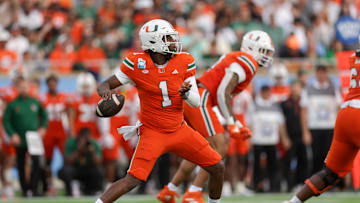Dec 28, 2024; Orlando, FL, USA; Miami Hurricanes quarterback Cam Ward (1) drops back to pass against the Iowa State Cyclones in the first quarter during the Pop Tarts bowl at Camping World Stadium. Mandatory Credit: Nathan Ray Seebeck-Imagn Images