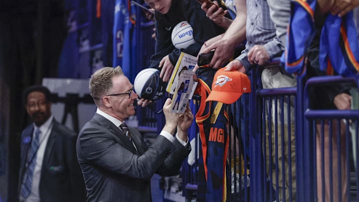 Nov 10, 2024; Oklahoma City, Oklahoma, USA; Oklahoma City Thunder general manager Sam Presti signs autographs before the start of a game against the Golden State Warriors at Paycom Center. Mandatory Credit: Alonzo Adams-Imagn Images