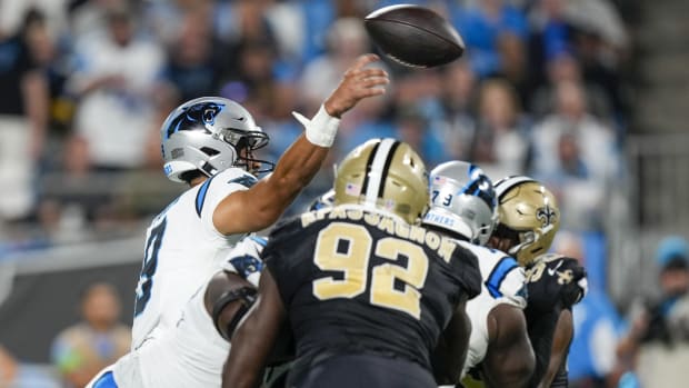 Carolina quarterback Bryce Young (9) throws under pressure from New Orleans Saints defensive end Tanoh Kpassagnon (92)