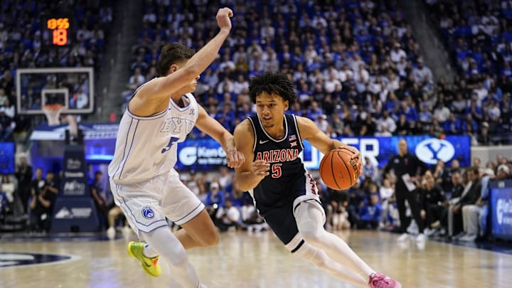Jan 26, 2026; Provo, Utah, USA; Arizona Wildcats guard Brayden Burries (5) drives to the basket while being defended by BYU Cougars forward Mihailo Bošković (5) at Marriott Center. Mandatory Credit: Aaron Baker-Imagn Images 