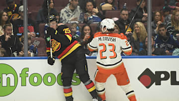 Apr 5, 2025; Vancouver, British Columbia, CAN;  Anaheim Ducks forward Mason McTavish (23) checks Vancouver Canucks defenseman Elias Pettersson (25) during the first period at Rogers Arena. Mandatory Credit: Anne-Marie Sorvin-Imagn Images