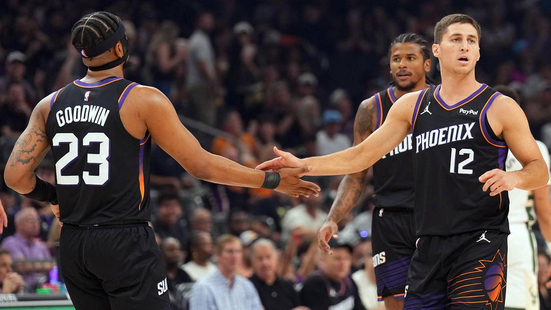 Mar 21, 2026; Phoenix, Arizona, USA; Phoenix Suns guard Jordan Goodwin (23) and Phoenix Suns guard Collin Gillespie (12) slap hands against the Milwaukee Bucks during the first half at Mortgage Matchup Center. Mandatory Credit: Joe Camporeale-Imagn Images