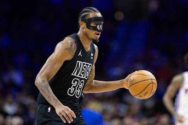 Brooklyn Nets center Nic Claxton dribbles the ball in an NBA game against the Philadelphia 76ers