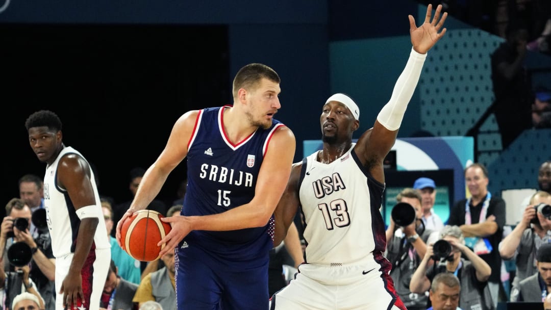 Aug 8, 2024; Paris, France; Serbia power forward Nikola Jokic (15) controls the ball while defended by United States centre Bam Adebayo (13) during the first half in a men's basketball semifinal game during the Paris 2024 Olympic Summer Games at Accor Arena. Mandatory Credit: Rob Schumacher-USA TODAY Sports