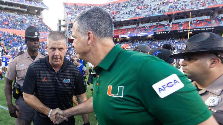 Florida Gators head coach Billy Napier, left shakes hands with Miami Hurricanes head coach Mario Cristobal after the Hurricanes defeated the Gators during the season opener at Ben Hill Griffin Stadium in Gainesville, FL on Saturday, August 31, 2024 against the University of Miami Hurricanes. The Hurricanes defeated the Gators 41-17. [Doug Engle/Gainesville Sun]