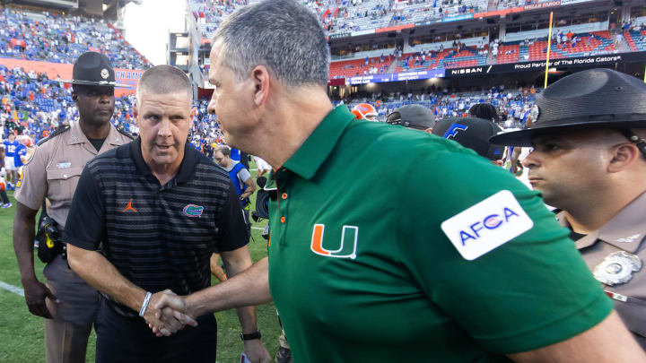 Florida Gators head coach Billy Napier, left shakes hands with Miami Hurricanes head coach Mario Cristobal after the Hurricanes defeated the Gators during the season opener at Ben Hill Griffin Stadium in Gainesville, FL on Saturday, August 31, 2024 against the University of Miami Hurricanes. The Hurricanes defeated the Gators 41-17. [Doug Engle/Gainesville Sun]