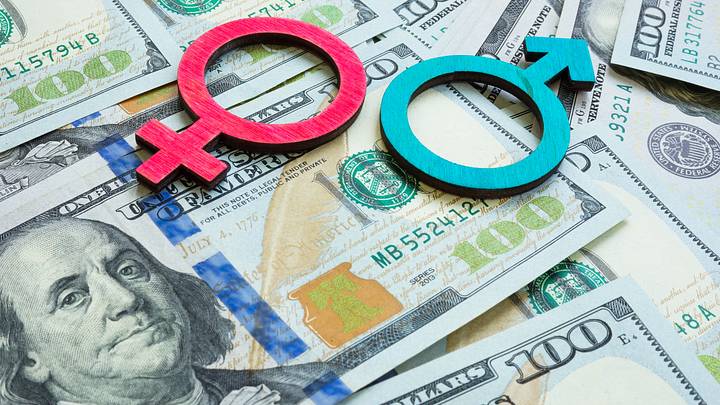 Salary and wage gap concept. Gender symbols and money.