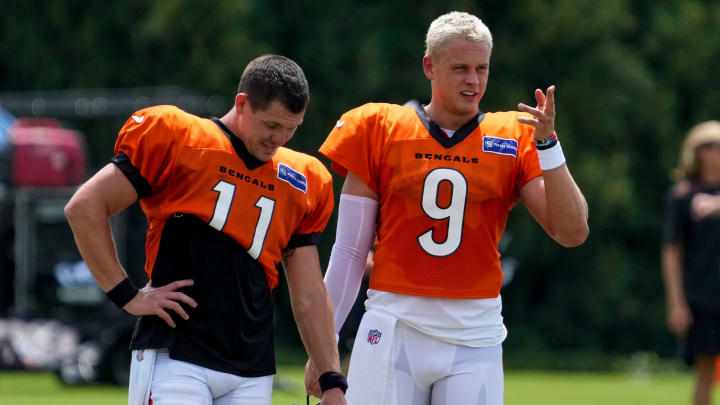 Cincinnati Bengals quarterback Joe Burrow (9) talks with quarterback Logan Woodside (11) during a preseason training camp practice at the Paycor Stadium practice field in downtown Cincinnati on Wednesday, Aug. 7, 2024.