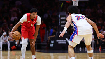 Nov 18, 2024; Miami, Florida, USA; Miami Heat guard Dru Smith (12) dribbles the basketball as Philadelphia 76ers guard Jared McCain (20) defends during the second quarter at Kaseya Center. Mandatory Credit: Sam Navarro-Imagn Images