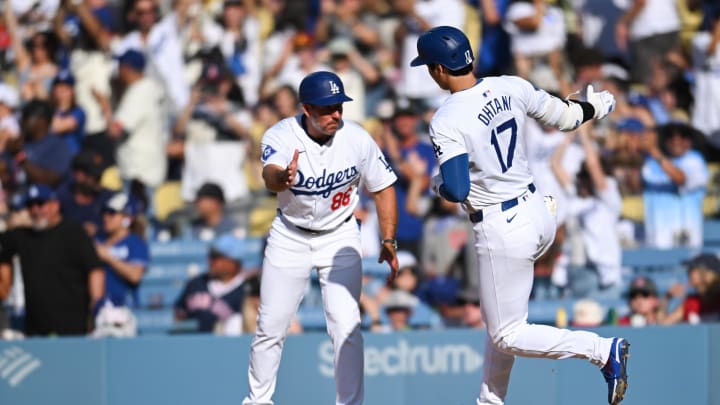 Los Angeles Dodgers designated hitter Shohei Ohtani (17) celebrates with first base coach Clayton McCullough (86) after hitting a home run against the Boston Red Sox during the fifth inning at Dodger Stadium on July 21.