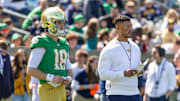 Quarterback Steve Angeli (18) stands alongside head coach Marcus Freeman during the Blue-Gold game at Notre Dame Stadium. 