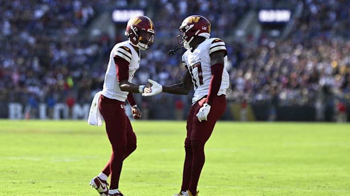 Oct 13, 2024; Baltimore, Maryland, USA;Washington Commanders quarterback Jayden Daniels (5) celebrates with Washington Commanders wide receiver Terry McLaurin (17) after catching a fourth quarter touchdown  against the Baltimore Ravens at M&T Bank Stadium. Mandatory Credit: Tommy Gilligan-Imagn Images