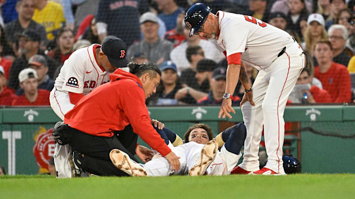 Boston Red Sox first baseman Triston Casas (36) is attended to by coaching and medical staff during the second inning against the Minnesota Twins at Fenway Park.