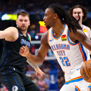 May 18, 2024; Dallas, Texas, USA;  Oklahoma City Thunder guard Cason Wallace (22) drives to the basket as Dallas Mavericks guard Luka Doncic (77) defends during the second quarter in game six of the second round of the 2024 NBA playoffs at American Airlines Center. Mandatory Credit: Kevin Jairaj-USA TODAY Sports