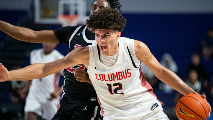 Columbus Explorers forward Cameron Boozer (12) drives to the basket against Archbishop Ryan Raiders forward Jaden Murray (22) during the third quarter of a game during the 50th annual City of Palms Classic at Suncoast Credit Union Arena in Fort Myers on Tuesday, Dec. 19, 2023.