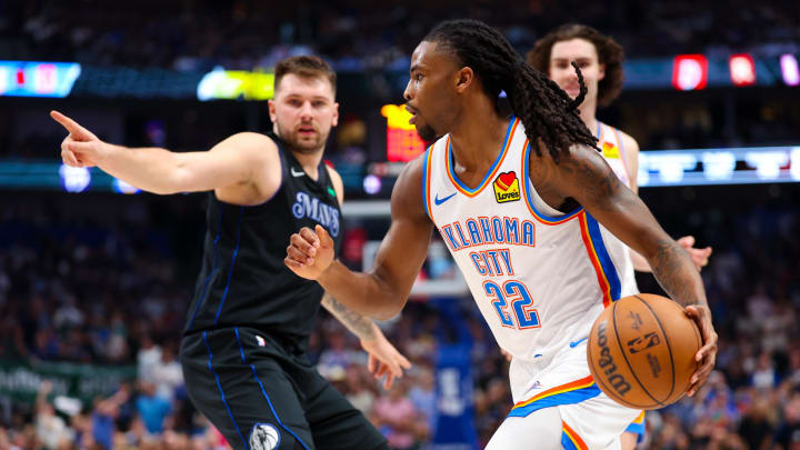 May 18, 2024; Dallas, Texas, USA;  Oklahoma City Thunder guard Cason Wallace (22) drives to the basket as Dallas Mavericks guard Luka Doncic (77) defends during the second quarter in game six of the second round of the 2024 NBA playoffs at American Airlines Center. Mandatory Credit: Kevin Jairaj-USA TODAY Sports