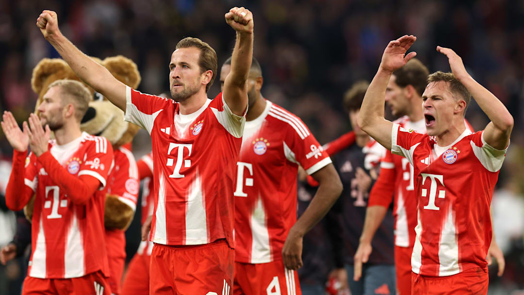 Bayern Munich players celebrating with fans after win against Borussia Dortmund.