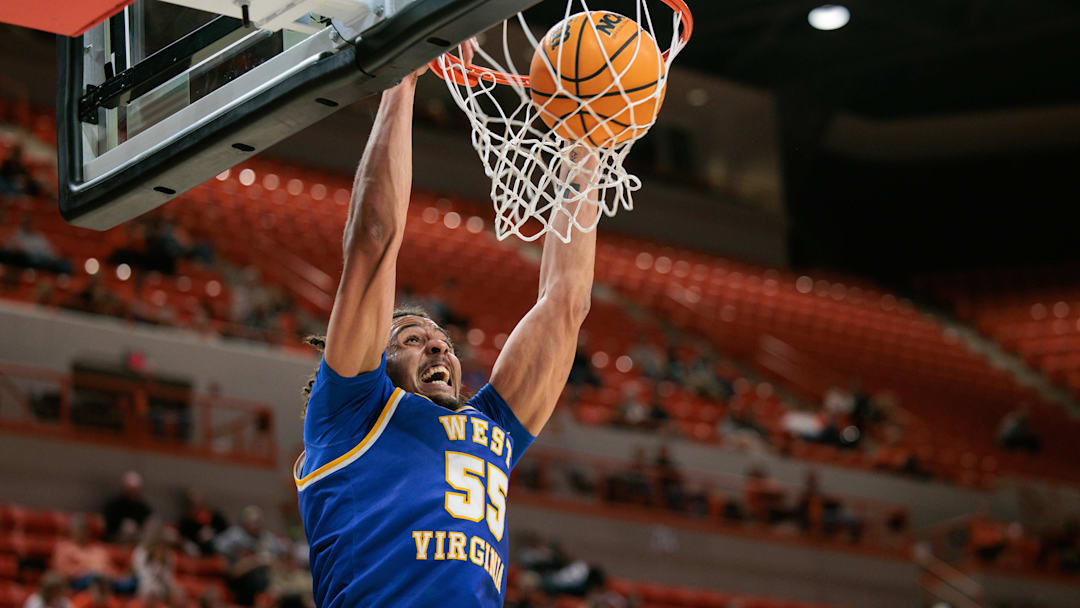 Feb 24, 2026; Stillwater, Oklahoma, USA; West Virginia Mountaineers center Harlan Obioha (55) dunks during the first half against the Oklahoma State Cowboys at Gallagher-Iba Arena. Mandatory Credit: William Purnell-Imagn Images