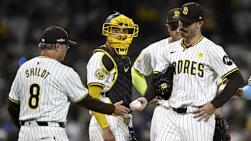 Oct 9, 2024; San Diego, California, USA; San Diego Padres manager Mike Shildt (8) takes out pitcher Dylan Cease (84) in the second inning against the Los Angeles Dodgers during game four of the NLDS for the 2024 MLB Playoffs at Petco Park.  Mandatory Credit: Denis Poroy-Imagn Images