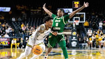  Wichita State Shockers guard Justin Hill (11) drives around South Florida Bulls guard Jayden Reid (0) during the second half at Charles Koch Arena. Mandatory Credit: William Purnell-Imagn Images