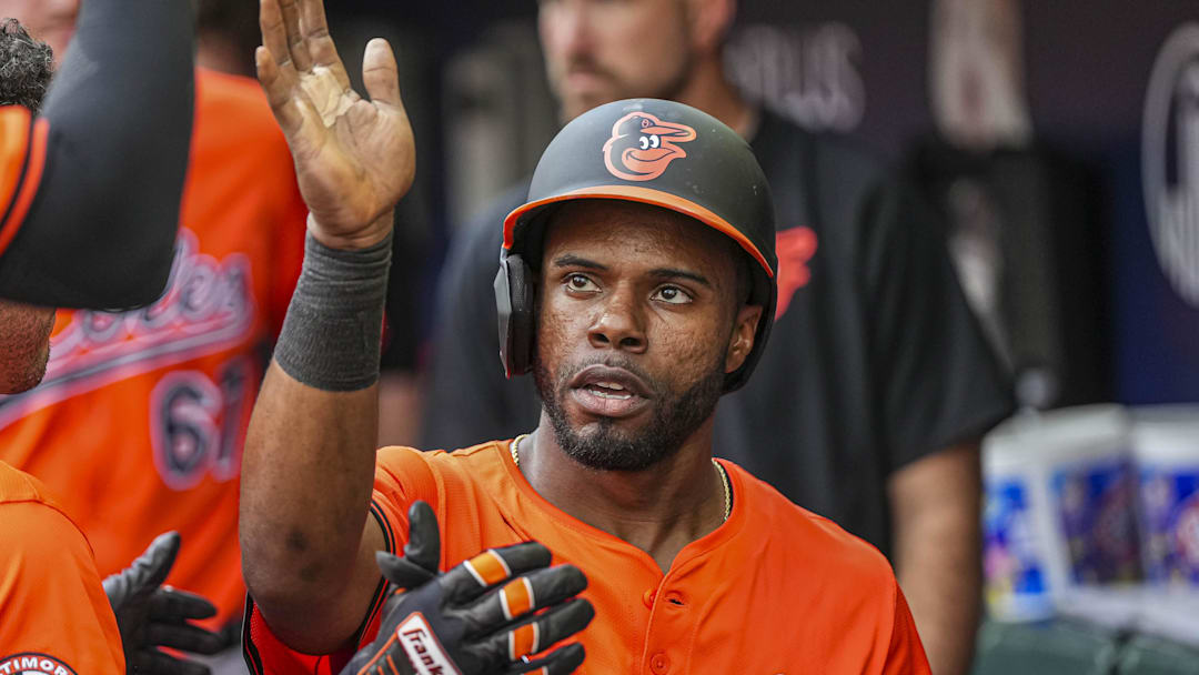 Jul 5, 2025; Cumberland, Georgia, USA; Baltimore Orioles center fielder Cedric Mullins (31) gets handshakes in the dugout after scoring a run against the Atlanta Braves during the seventh inning at Truist Park. 