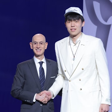 Jun 25, 2025; Brooklyn, NY, USA;  Yang Hansen stands with NBA commissioner Adam Silver after being selected as the 16th pick by the Memphis Grizzlies in the first round of the 2025 NBA Draft at Barclays Center. Mandatory Credit: Brad Penner-Imagn Images
