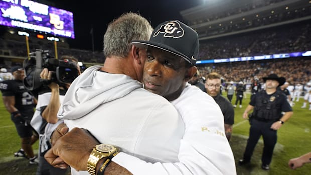 TCU Horned Frogs head coach Sonny Dykes and Colorado Buffaloes head coach Deion Sanders hug following a game at Amon G. Carte